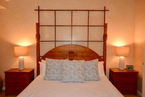 a bedroom with a large bed with two night stands at Ocean Pearl in Kahuku