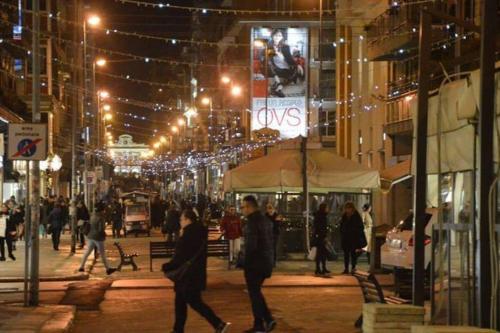 a group of people walking down a city street at night at AL VECCHIO ARCO a Bari vecchia in Bari