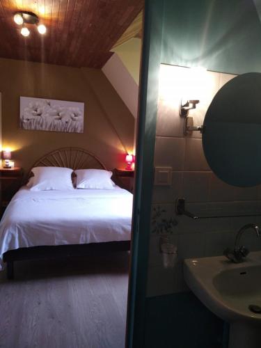 a bedroom with a bed and a sink in a room at Hôtel du Pont et Restaurant à Groléjac in Groléjac