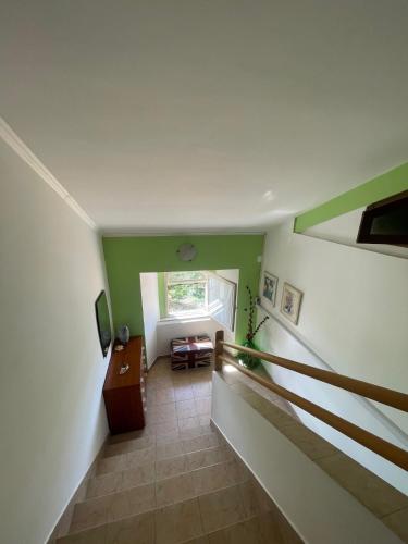 an attic hallway with a staircase and a window at La Locanda Del Re in Villalfonsina