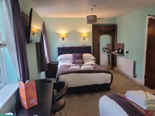 a hotel room with two beds and a table at The Bingham Townhouse in Bingham