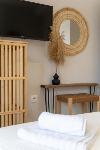a bedroom with a bed and a mirror on the wall at Helicon Luxury Villas in Limenas