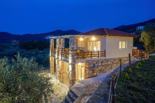 a house under construction at night with lights at Helicon Luxury Villas in Limenas
