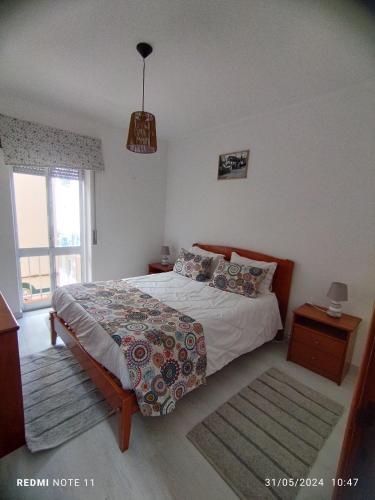 Ένα ή περισσότερα κρεβάτια σε δωμάτιο στο Apartamentos das Avós-Flor