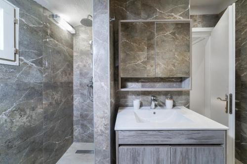 a bathroom with a sink and a shower at Helicon Luxury Villas in Limenas