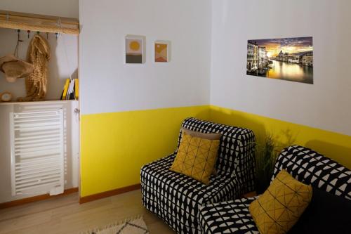 a living room with a couch and a chair at La Perla del Sole - Sunset on the beach in Lido di Pomposa