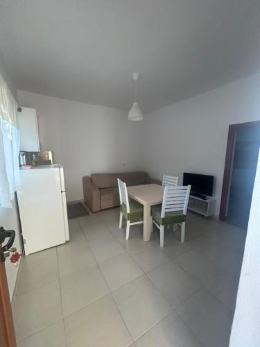 a kitchen with a table and chairs and a refrigerator at Villa B&E 2 in Vlorë