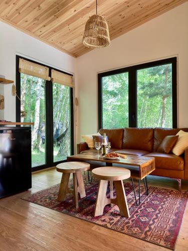 a living room with a couch and a table at Domek nad Zegrzem z prywatnym jacuzzi in Arciechow