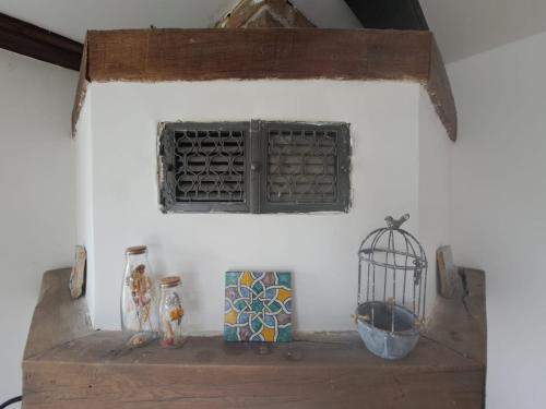 a shelf with a window and a bird cage on it at Haus Eufalia in Blankenheim