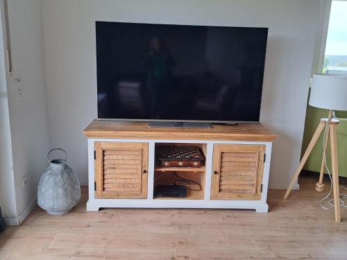 a flat screen tv sitting on top of a cabinet at Haus Eufalia in Blankenheim