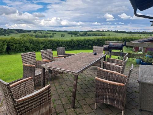 a wooden table and chairs on a patio at Haus Eufalia in Blankenheim