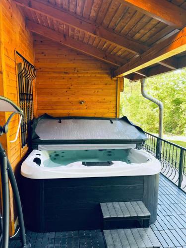 a jacuzzi tub sitting on a deck at Favilla Apartmanok in Bogács