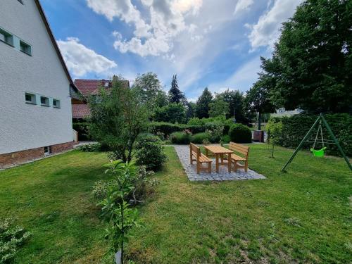 a garden with a picnic table and a swing at Ferien Oase am BER in Schönefeld