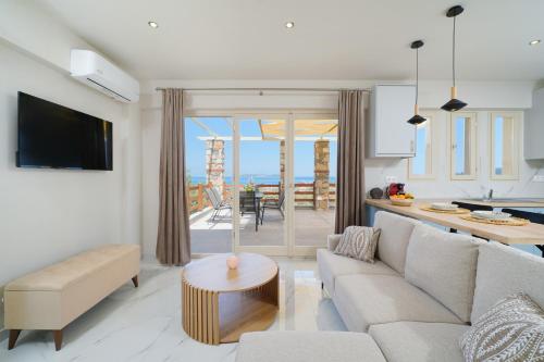a living room with a couch and a table at Helicon Luxury Villas in Limenas