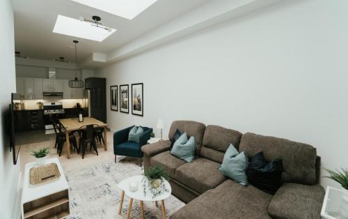 a living room with a couch and a table at Welcoming and Light Filled 2bdr Apartment in Montréal