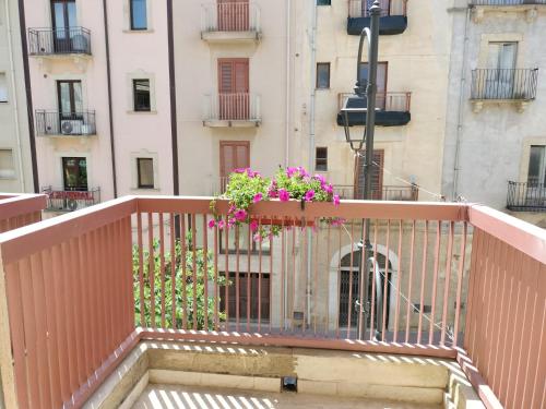 a balcony with a planter with flowers on it at D&P Suites 2 Salemi in Salemi