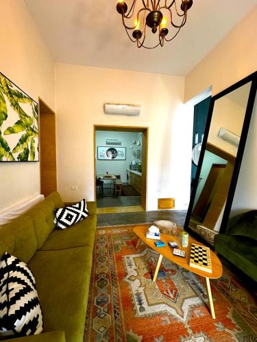 a living room with a couch and a table at El Sayed House in ‘Akko