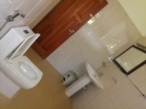 a bathroom with a white toilet and a sink at Paradise villa aluthgama in Aluthgama