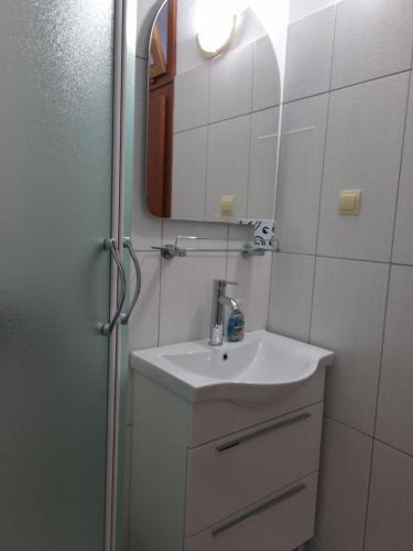 La salle de bains est pourvue d'un lavabo et d'un miroir. dans l'établissement Villa Oliva, à Makarska