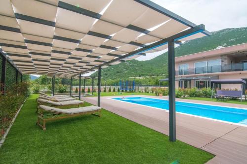 a pergola over a backyard with a swimming pool at Villa Sky D 9&1 with tennis court and heated pool in Omiš