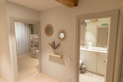 a bathroom with a sink and a mirror at TuApartamento - Zapateria 30 in Pamplona