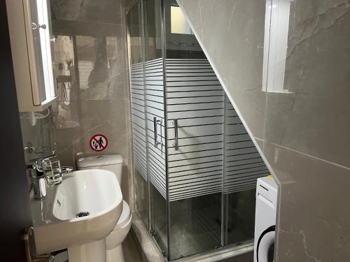 a bathroom with a toilet and a walk in shower at Elegant Loft 2 in Alexandroupoli