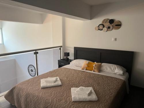 a bedroom with a bed with two towels on it at Elegant Loft 2 in Alexandroupoli