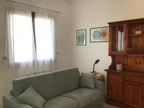 a living room with a couch and a window at Casa LORE in Castelbuono