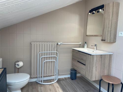 a bathroom with a sink and a toilet at Les Apparts de la Tourronde in Chorges