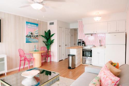 a kitchen and living room with a couch and a table at Beach-Pool-Private Balcony in Tybee Island