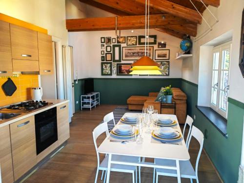 a kitchen and dining room with a white table and chairs at Jungle in Lucca in Capannori
