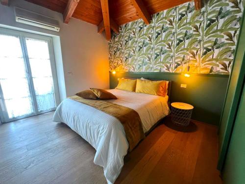 a bedroom with a bed with a mural on the wall at Jungle in Lucca in Capannori