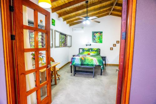 a bedroom with a bed and a table at Casitas Del Rio Riverfront Nature Lodge in Uvita