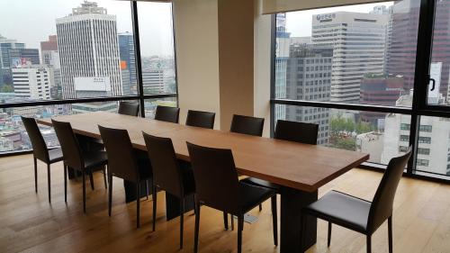 a dining room with a large table and chairs at Sotetsu Hotels The Splaisir Seoul Myeongdong in Seoul