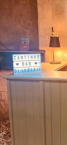 a sign on top of a table in a room at Cantinho das Oliveiras in Geres