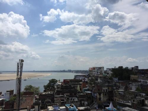 a view of a city with a beach and buildings at GRG Shanti Guest House Varanasi Near Manikarnika Ghat in Varanasi