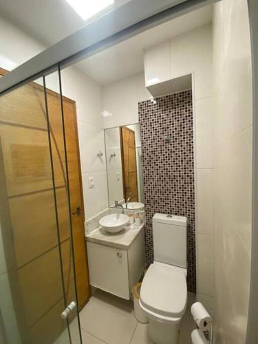 a bathroom with a toilet and a sink at Studio Luxury Copa - beira mar in Rio de Janeiro