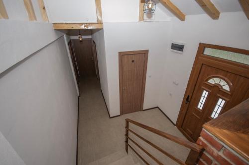 an overhead view of a hallway with a wooden door at Arаbeska Family Winery & Apartments in Kavadarci