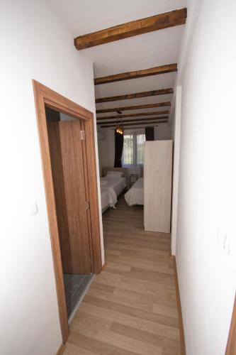 a hallway leading to a bedroom with two beds at Arаbeska Family Winery & Apartments in Kavadarci