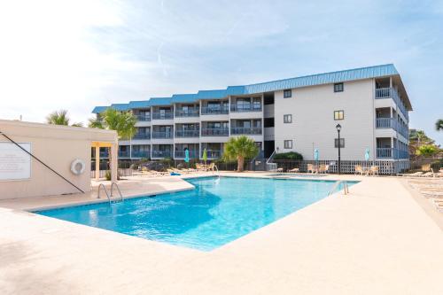 a swimming pool in front of a hotel at Beach-Pool-Private Balcony in Tybee Island