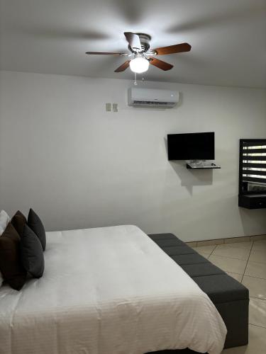 a bedroom with a bed and a ceiling fan at VILLAS EL ENCANTO in Jalpan