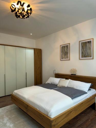 a bedroom with a wooden bed and a chandelier at Hotel zum Rittersprung in Altenahr