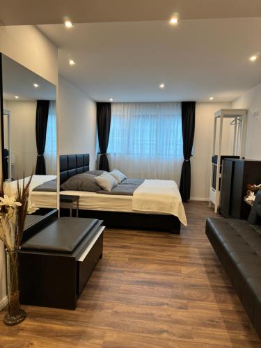 a bedroom with a large bed and a couch at Hotel zum Rittersprung in Altenahr