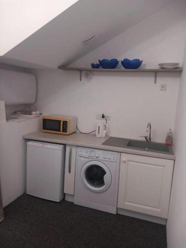 a kitchen with a washing machine and a sink at Studio 11T near Monaco in Beausoleil