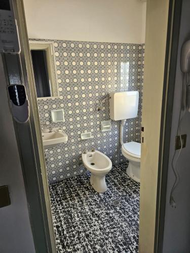 a bathroom with two toilets and a sink at PAPER MOON in Bellaria-Igea Marina