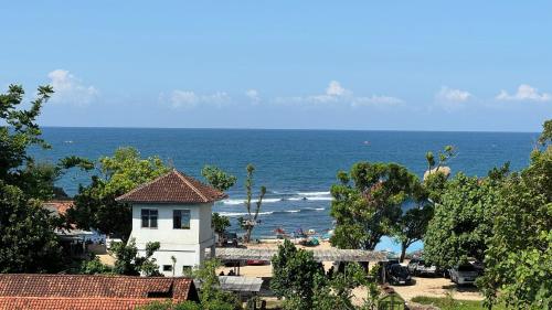 a house on the beach with the ocean in the background at Villa Orion Sundak in Tepus