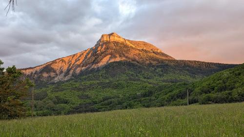 a mountain with the sun shining on it at Le Galussel Gite d'étape et de séjour in Saint-Sébastien