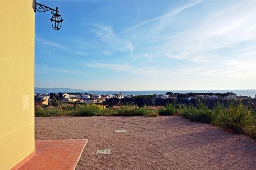 a view from the porch of a yellow house with a view at Maremma 1851 in Follonica