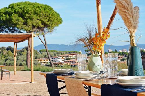 a wooden table with plates and vases on it at Maremma 1851 in Follonica