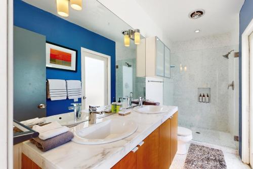 a bathroom with two sinks and a blue wall at Tres Palmas Permit# 384 in Palm Springs